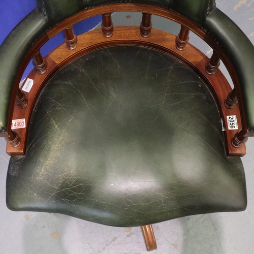 2056 - 20th century green leather captains style desk chair, on five-spoke swivel base, studded and buttone... 