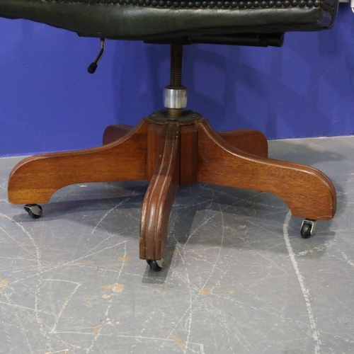 2056 - 20th century green leather captains style desk chair, on five-spoke swivel base, studded and buttone... 