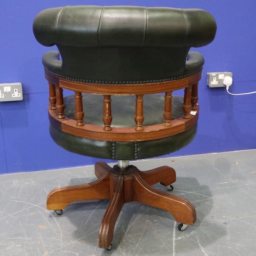 2056 - 20th century green leather captains style desk chair, on five-spoke swivel base, studded and buttone... 