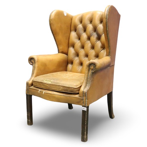 2033 - Early 20th century distressed tan leather Chesterfield wingback fireside armchair. Not available for... 