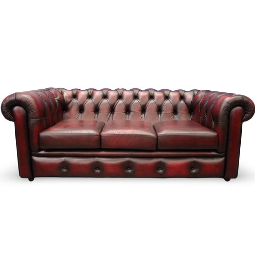 2042 - A modern Chesterfield three-seat sofa in ox-blood red leather. Not available for in-house P&P