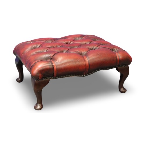 2051 - 20th century Chesterfield style footstool, studded and buttoned ox-blood red leather over a mahogany... 