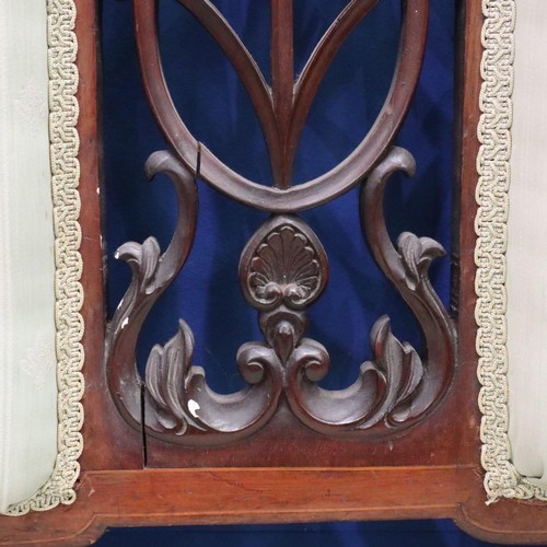 2025 - An Edwardian two-seat settee, inlaid walnut frame with upholstered and carved backrest, raised on ta... 