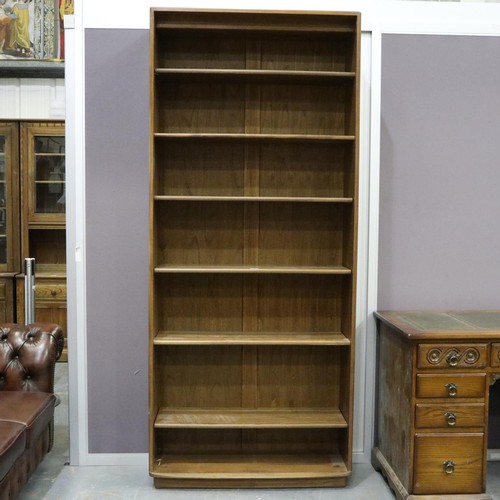 2054 - Ercol Golden Dawn elm bookcase having six fixed shelves. Not available for in-house P&P