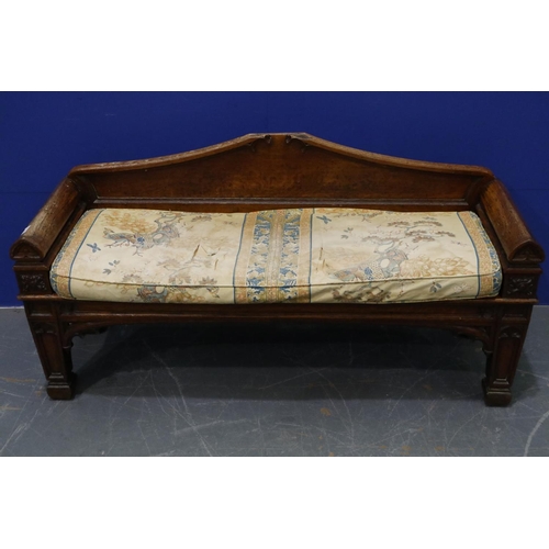 2044 - An early 19th century carved oak settle or window seat, decorated in the Gothic manner, with straw-f... 