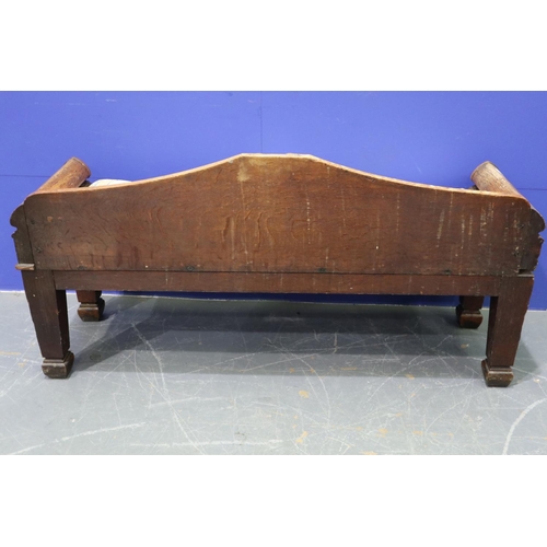 2044 - An early 19th century carved oak settle or window seat, decorated in the Gothic manner, with straw-f... 