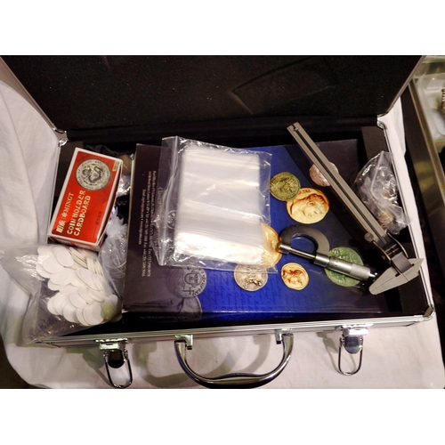 1143 - Case of numismatic accessories to include holders,capsules, references, magnifier, calipers and coin... 