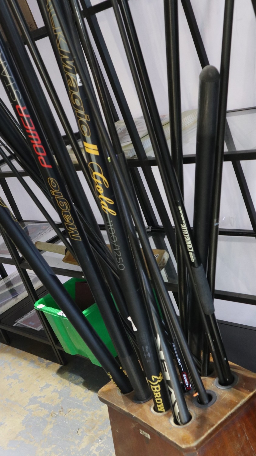 Large collection of mixed fishing rods.
