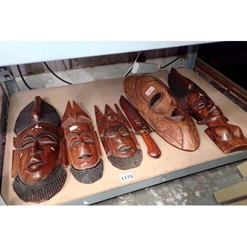 1175 - Five African wall masks and a wooden Indian style knife. Not available for in-house P&P