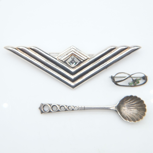 101 - Two silver brooches and a silver scalloped spoon, 13g combined. UK P&P Group 0 (£7+VAT for the first... 