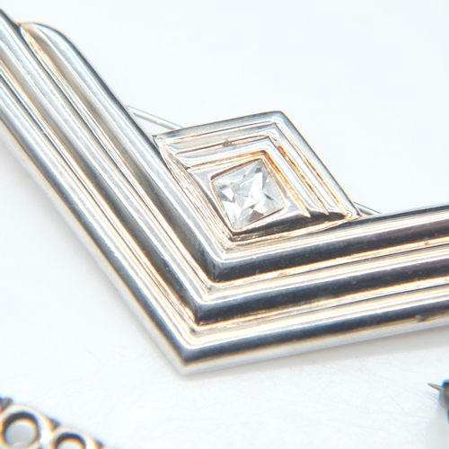 101 - Two silver brooches and a silver scalloped spoon, 13g combined. UK P&P Group 0 (£7+VAT for the first... 