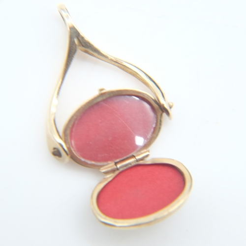 105 - 9ct gold spinner with locket, H: 30 mm, 2.4g. UK P&P Group 0 (£7+VAT for the first lot and £1+VAT fo... 