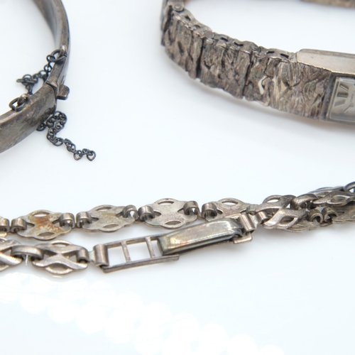 113 - Two silver bangles, a bracelet and a textured Accurist ladies wristwatch, 73g combined. UK P&P Group... 