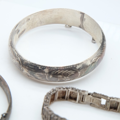 113 - Two silver bangles, a bracelet and a textured Accurist ladies wristwatch, 73g combined. UK P&P Group... 