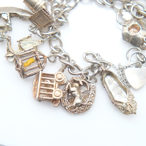 139 - Silver bracelet with twenty charms and padlock clasp, 72g. UK P&P Group 1 (£18+VAT for the first lot... 