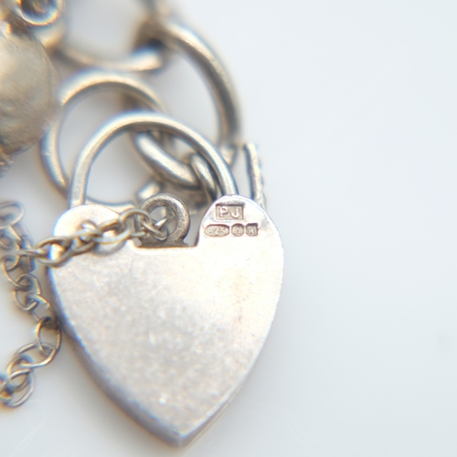 139 - Silver bracelet with twenty charms and padlock clasp, 72g. UK P&P Group 1 (£18+VAT for the first lot... 