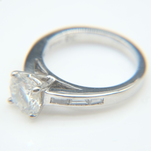61 - Platinum 1.8ct round brilliant cut diamond set ring with baguette cut diamonds to the shoulders, siz... 