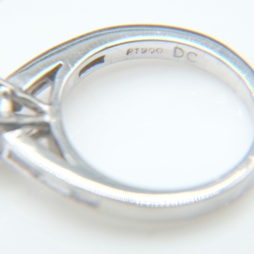 61 - Platinum 1.8ct round brilliant cut diamond set ring with baguette cut diamonds to the shoulders, siz... 