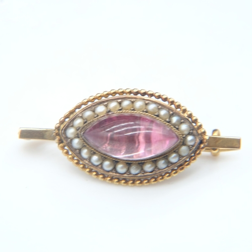 80 - 19th Century unmarked gold brooch, with a domed marquis-shaped glass cabochon with red foiled back s... 