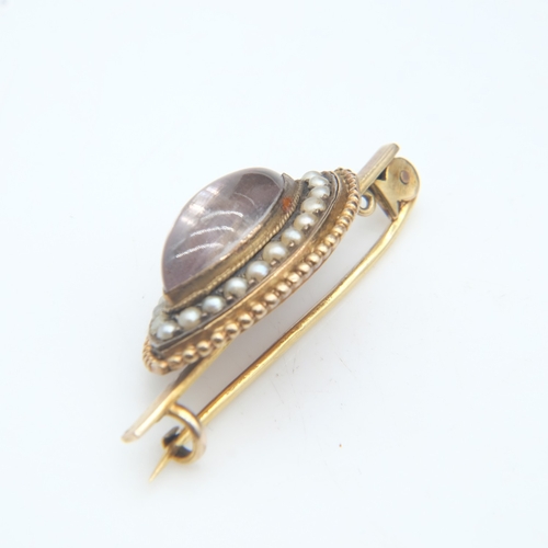 80 - 19th Century unmarked gold brooch, with a domed marquis-shaped glass cabochon with red foiled back s... 