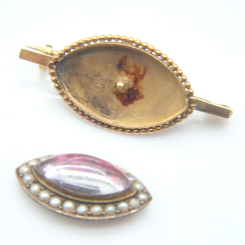 80 - 19th Century unmarked gold brooch, with a domed marquis-shaped glass cabochon with red foiled back s... 