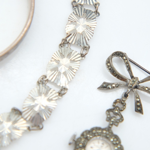 94 - Hallmarked silver bangle with chased decoration and safety chain, a silver panel bracelet and a marc... 