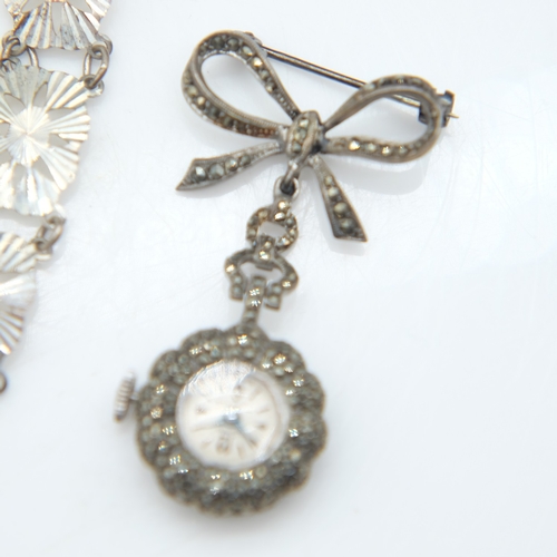 94 - Hallmarked silver bangle with chased decoration and safety chain, a silver panel bracelet and a marc... 