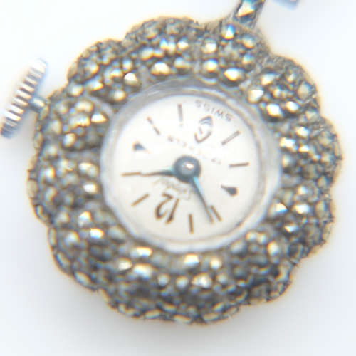 94 - Hallmarked silver bangle with chased decoration and safety chain, a silver panel bracelet and a marc... 