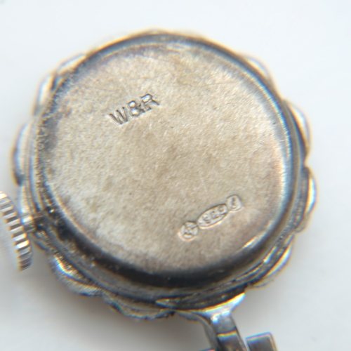 94 - Hallmarked silver bangle with chased decoration and safety chain, a silver panel bracelet and a marc... 