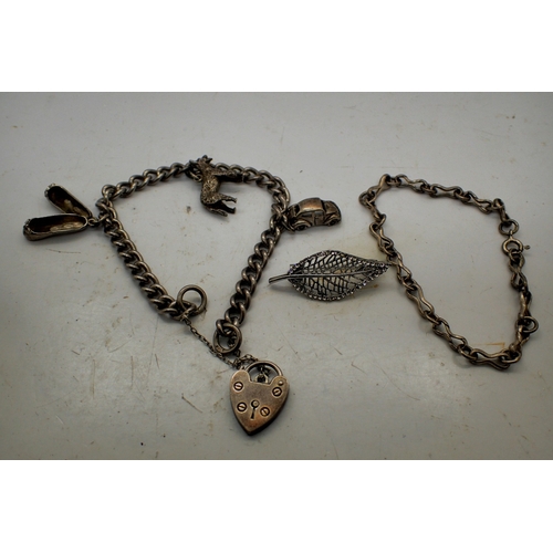 1054 - Hallmarked silver bracelet with three charms and padlock clasp, with a 925 silver bracelet, 32g comb... 
