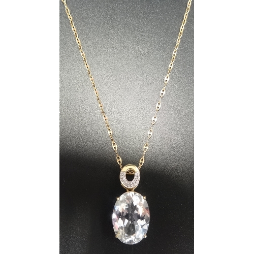 34 - DIAMOND AND GEM SET PENDANT
the oval cut gemstone (possibly topaz) below smaller diamonds, in nine c... 