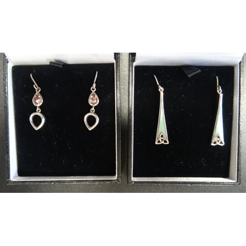 76 - TWO PAIRS OF SILVER DROP EARRINGS
one pair set with mother of pearl above pierced triquetra decorati... 