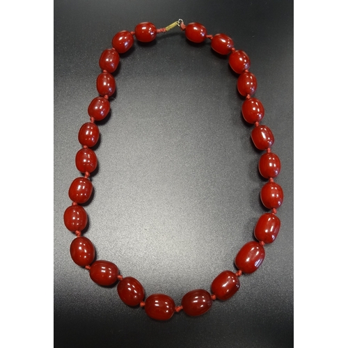 86 - CHERRY AMBER BEAD NECKLACE
approximately 45cm long; together with a large cherry amber loose bead, t... 