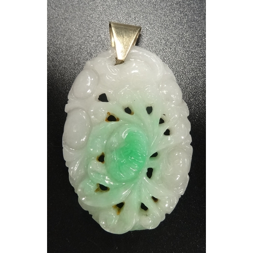 100 - CARVED JADE PENDANT
with stylised floral decoration, in unmarked gold mount, 3.7cm high excluding su... 