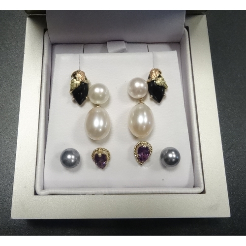 127 - FOUR PAIRS OF EARRINGS
comprising a pair of pearl drop earrings on nine carat gold mounts; a pair of... 