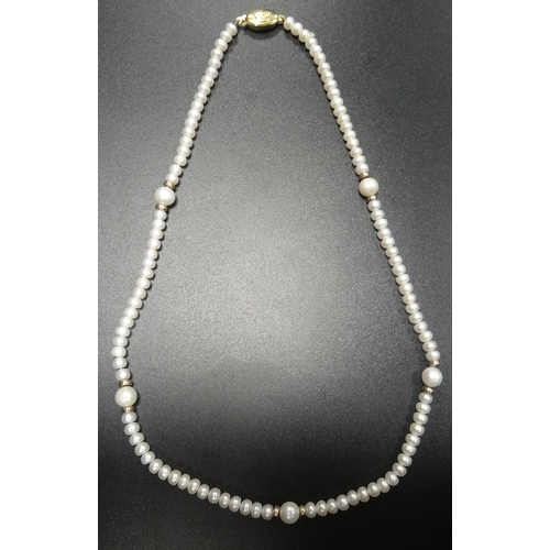 133 - PEARL NECKLACE 
the small pearls interspersed with larger pearls and gold spacers, with nine carat g... 