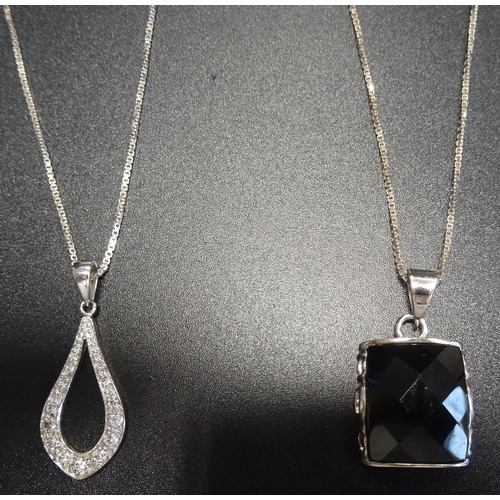 141 - SILVER CZ SET PENDANT
on silver chain; together with another silver mounted pendant on silver chain,... 