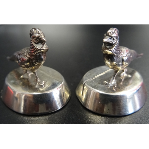 151 - PAIR OF SILVER SAMPSON MORDAN PLACE HOLDERS
decorated with pheasants, Chester hallmarks for 1913, 2.... 