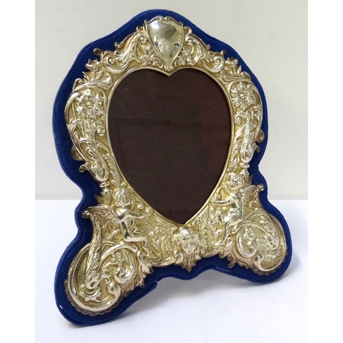156 - VICTORIAN STYLE SILVER PHOTOGRAPH FRAME
the heart shaped frame with profuse scroll, floral and cheru... 