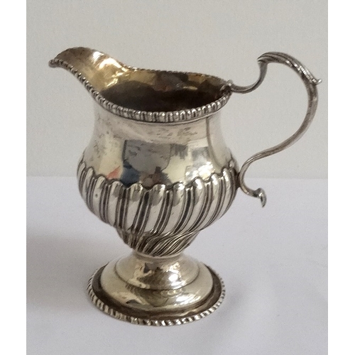 162 - GEORGE III SILVER CREAM JUG
with gadrooned decoration to the body and a beaded rim, London hallmarks... 