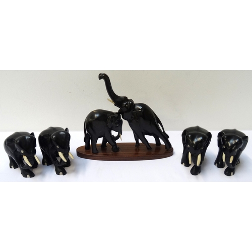 261 - GROUP OF CARVED EBONISED ELEPHANTS
with bone tusks and some with bone toe detail (5)  - RE-OFFERED I... 