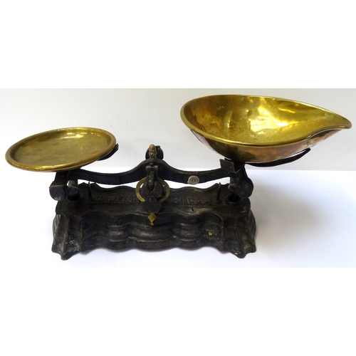 273 - SET OF EARLY 20TH CENTURY SHOP SCALES
with a shaped cast iron base with brass weighing and shaped go... 