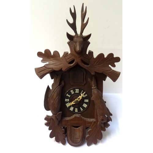 276 - BLACK FOREST CUCKOO CLOCK
with a carved case surmounted by a stag above a circular dial with Roman n... 