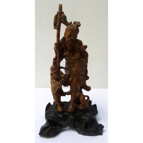 277 - JAPANESE CARVED BOXWOOD OKIMONO
depicting a fisherman with a young boy and fish, on a pierced ebonis... 