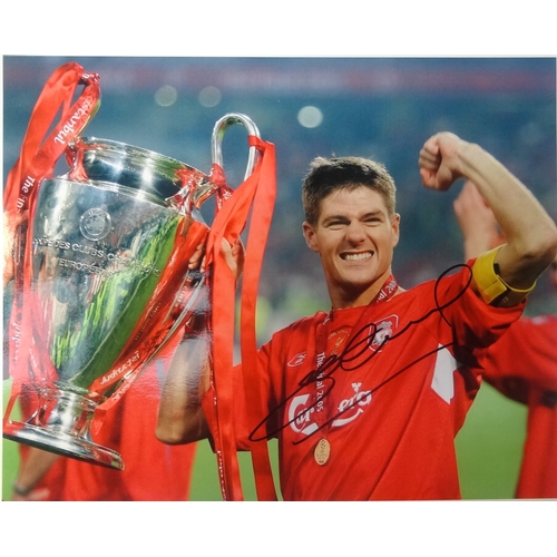 306 - STEVEN GERRARD SIGNED COLOUR PHOTOGRAPHIC PRINT 
holding the Champions League trophy, 20.5cm x 25.5c... 