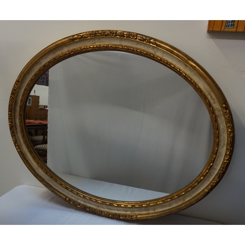 407 - OVAL WALL MIRROR 
the gilt frame with carved floral decoration, 91cm wide; together with an oblong w... 