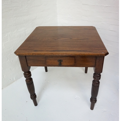 411 - EDWARDIAN OAK TEA TABLE 
the square top with canted corners, single drawer and raised on long turned... 