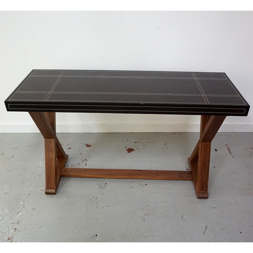 414 - LEATHER TOP SIDE TABLE
with decorative geometric stitching, standing on X frame supports, 125cm wide