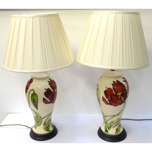 211 - PAIR OF MOORCROFT POTTERY TABLE LAMPS
with a cream ground and decorated with frilled orchids, standi... 