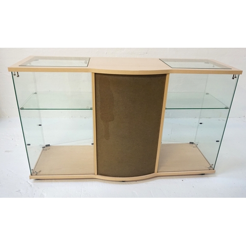 391 - PALE OAK EFFECT DISPLAY CABINET
with a shaped top with two inset glass panel sections above a centra... 